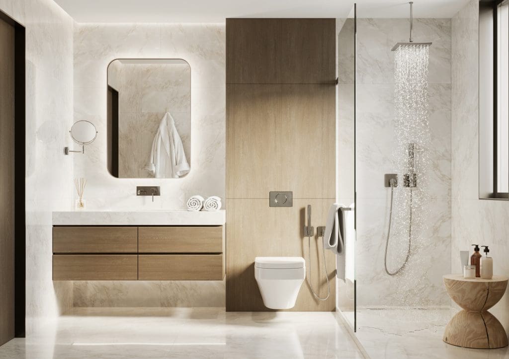 Modern bathroom with marble tiles and warm wood accents. Includes a large mirror above a wooden vanity with two drawers, a wall-mounted toilet, and a glass-enclosed rain shower. Natural light streams in from a window, illuminating the space.